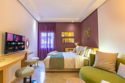 a hotel room with a bed and a couch at Central 1BR Studio- AC & IpTV-Self check in- 2 guests in Marrakech