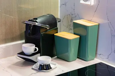 a coffee maker and two cups on a counter at Beautiful Apartment with Pool View Noria Golf in Marrakech