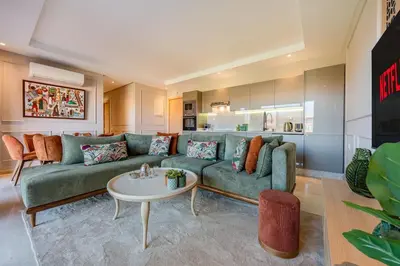 a living room with a green couch and a table at Beautiful Apartment with Pool View Noria Golf in Marrakech
