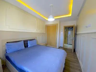 a bedroom with a large bed with blue pillows at דירה