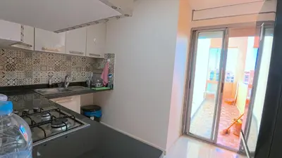 a kitchen with a stove and a window in it at דירה