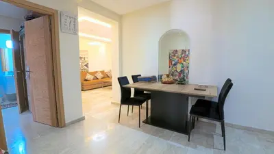 a dining room with a table and chairs at דירה