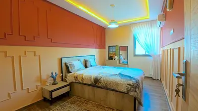 a bedroom with a large bed and a window at דירה