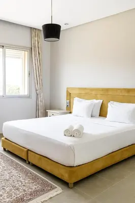 a bedroom with a large bed with two towels on it at La Villa Ocre in Marrakech