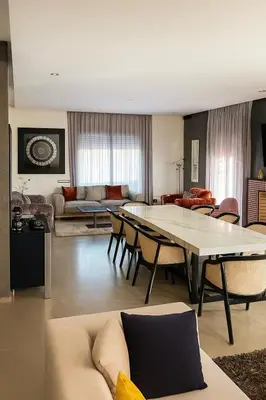 a large living room with a table and chairs at La Villa Ocre in Marrakech