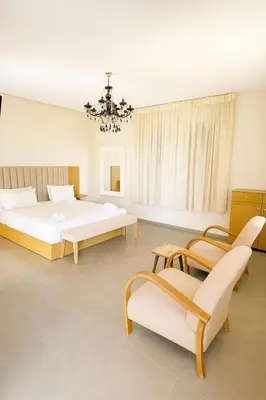 a bedroom with two beds and a chandelier at La Villa Ocre in Marrakech