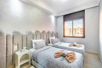 a bedroom with two beds and a window at Dreamy Home Climatisation and design in Oulad Akkou