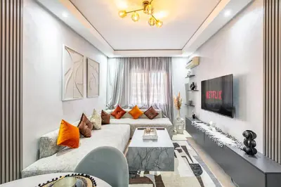 a living room with a couch and a tv at Dreamy Home Climatisation and design in Oulad Akkou