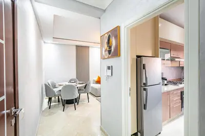a kitchen and dining room with a table and a refrigerator at Dreamy Home Climatisation and design in Oulad Akkou