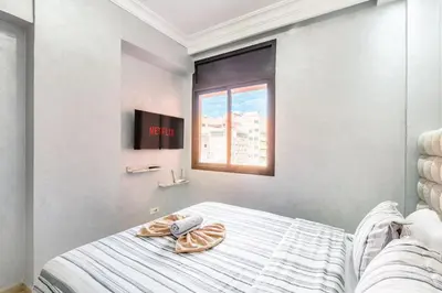 a bedroom with a bed and a window at Dreamy Home Climatisation and design in Oulad Akkou