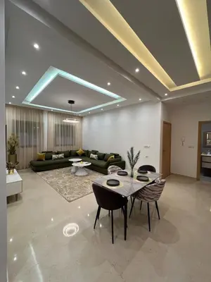 a living room with a couch and a table at Luxury apartment - Quiet and family-friendly neighborhood in Marrakech