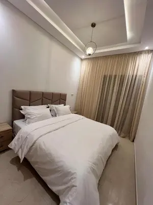 a bedroom with a large bed with white sheets at Luxury apartment - Quiet and family-friendly neighborhood in Marrakech