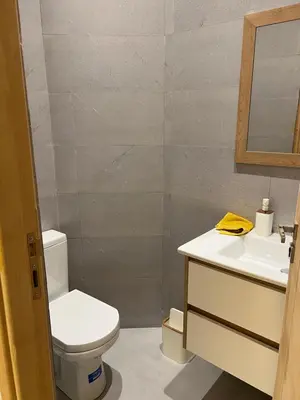 a bathroom with a toilet and a sink at Luxury apartment - Quiet and family-friendly neighborhood in Marrakech