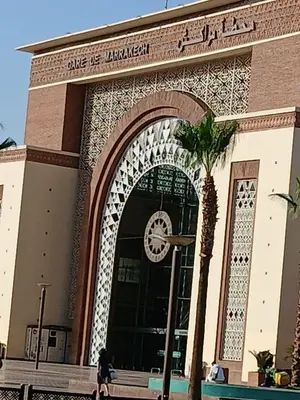 an entrance to a building with a clock on it at Evasion à Marrakech very centrally located in Marrakech