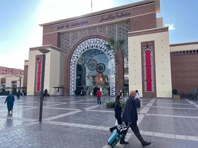 a man and a woman walking in front of a building at Evasion à Marrakech very centrally located in Marrakech