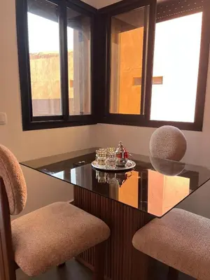 a dining room with a glass table and two chairs at Evasion à Marrakech very centrally located in Marrakech