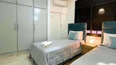 a bedroom with two beds with towels on them at Beautiful Bright Apartment Victor Hugo District in Marrakech