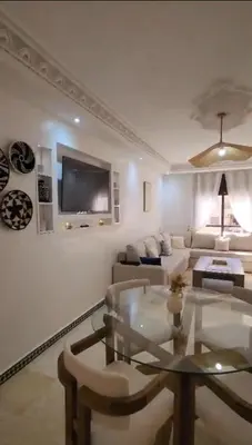 a living room with a couch and a table at Beautiful Bright Apartment Victor Hugo District in Marrakech