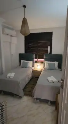 a room with two beds and a window at Beautiful Bright Apartment Victor Hugo District in Marrakech