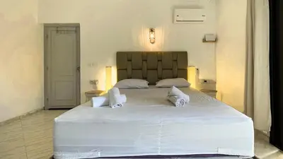 a bedroom with a large white bed with two pillows at Beautiful Bright Apartment Victor Hugo District in Marrakech