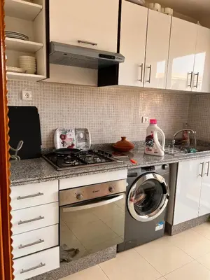 a kitchen with a stove and a washing machine at App RIAD JAWHARA in Marrakech