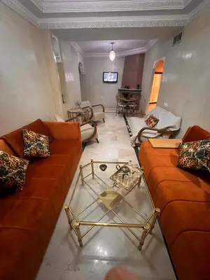 a living room with couches and a glass coffee table at App RIAD JAWHARA in Marrakech