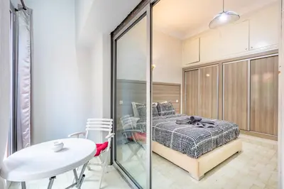 a bedroom with a bed and a table in a room at Cozy Nest balcony and bright in Marrakech
