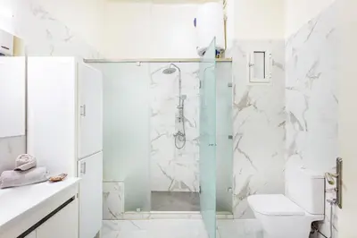a bathroom with a shower and a toilet at Cozy Nest balcony and bright in Marrakech