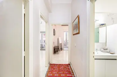 a hallway leading to a bathroom with a red rug at Cozy Nest balcony and bright in Marrakech