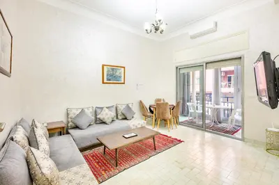 a living room with a couch and a table at Cozy Nest balcony and bright in Marrakech