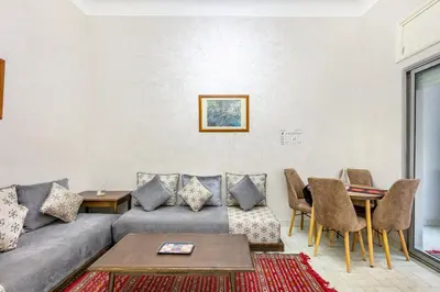 a living room with a couch and a table at Cozy Nest balcony and bright in Marrakech