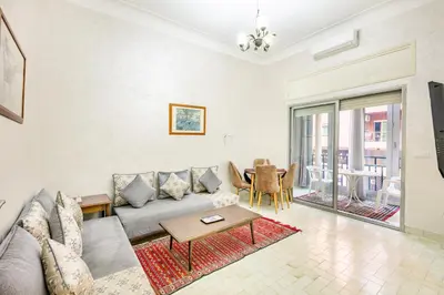 a living room with a couch and a table at Cozy Nest balcony and bright in Marrakech