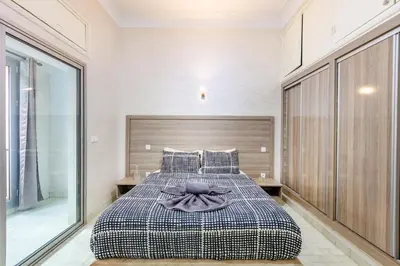 a bedroom with a bed with a purple bow on it at Cozy Nest balcony and bright in Marrakech