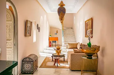 a living room with a couch and a table at Kasbah La Moun Luxury Riad & Spa in Marrakech