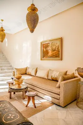 a living room with a couch and a table at Kasbah La Moun Luxury Riad & Spa in Marrakech