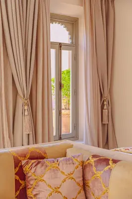 a bedroom with a bed with curtains and a window at Kasbah La Moun Luxury Riad & Spa in Marrakech