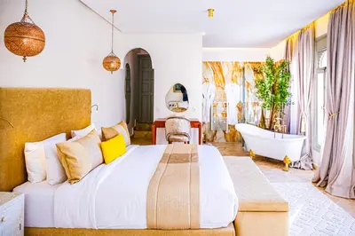 a bedroom with a large bed and a bath tub at Kasbah La Moun Luxury Riad & Spa in Marrakech