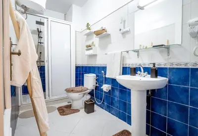 a blue and white bathroom with a toilet and a sink at Appartement de charme à Gueliz - Centre Marrakech in Marrakech