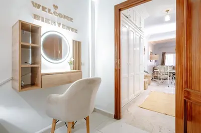 a white chair in a hallway with a dining room at Appartement de charme à Gueliz - Centre Marrakech in Marrakech