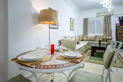 a living room with a table and a couch at Appartement de charme à Gueliz - Centre Marrakech in Marrakech