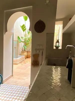 a bathroom with a sink and a tile floor at Riad Dar Bou Seta - Small Riad in Marrakech