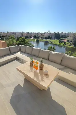 a table with fruit on it sitting on a patio at Penthouse Prestigia Village Panoramique sur le Lac in Marrakech