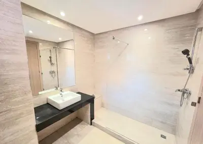a bathroom with a sink and a shower at Penthouse Prestigia Village Panoramique sur le Lac in Marrakech