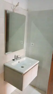 a bathroom with a white sink and a mirror at appartamento lalla Rita short-term rent in Marrakech