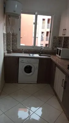 a kitchen with a sink and a washing machine at appartamento lalla Rita short-term rent in Marrakech