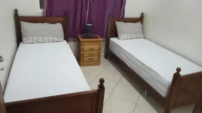 two beds in a small room with sidx sidx sidx at appartamento lalla Rita short-term rent in Marrakech