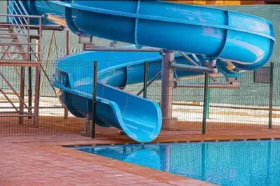 a blue water slide in a swimming pool at Résidence Soleil Vue Piscine in Marrakech