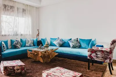 a blue couch and a table in a living room at Cocon au calme Residence Piscine Marrakech in Marrakech