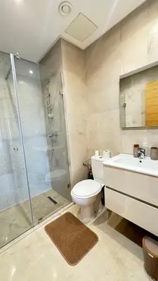 a bathroom with a shower and a toilet and a sink at Magnifique appartement in Marrakech