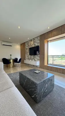 a living room with a large black marble coffee table at Magnifique appartement in Marrakech